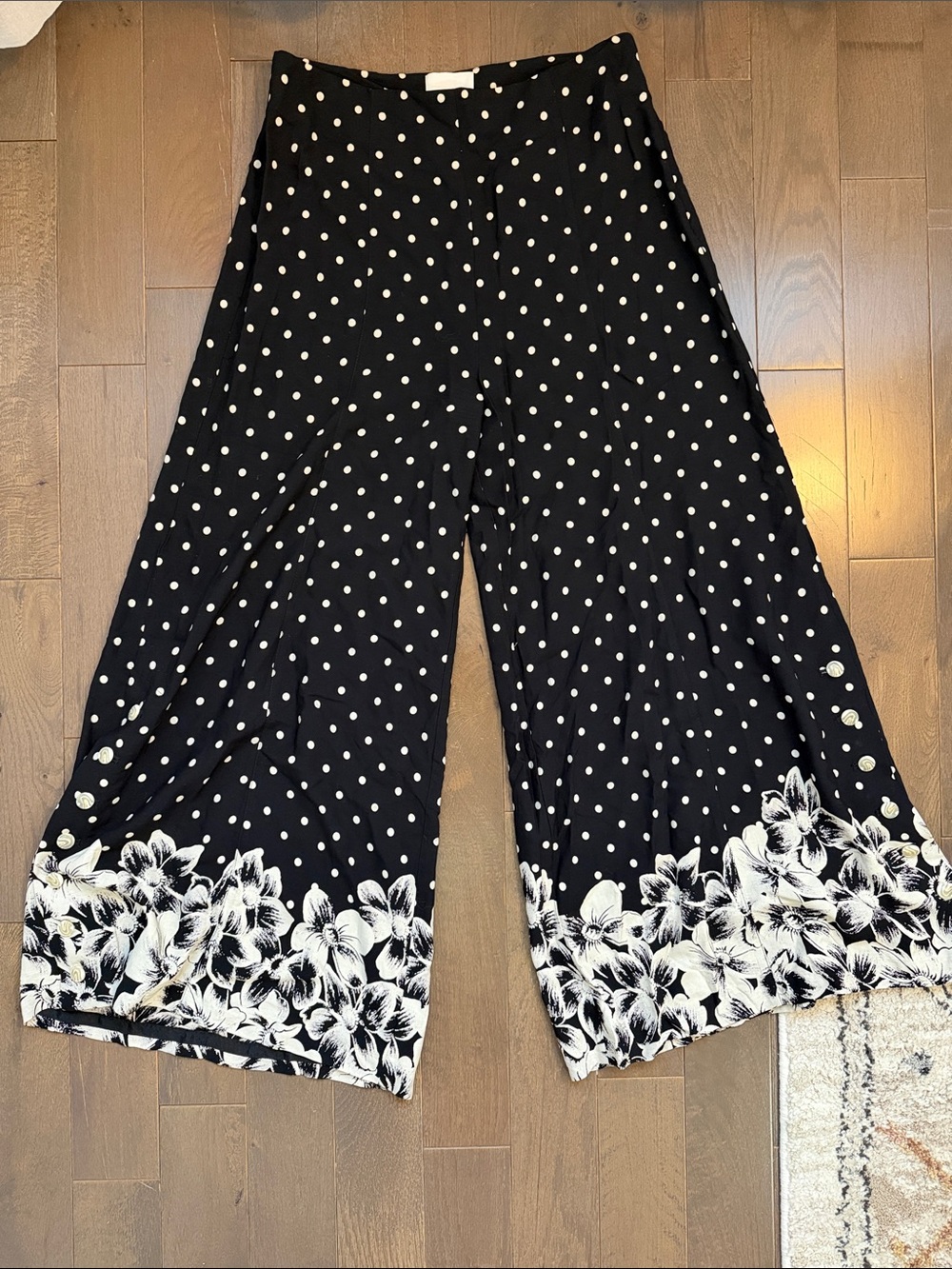 Anthropologie Black Polka Dot Wide Leg Pants with floral leg and button detail